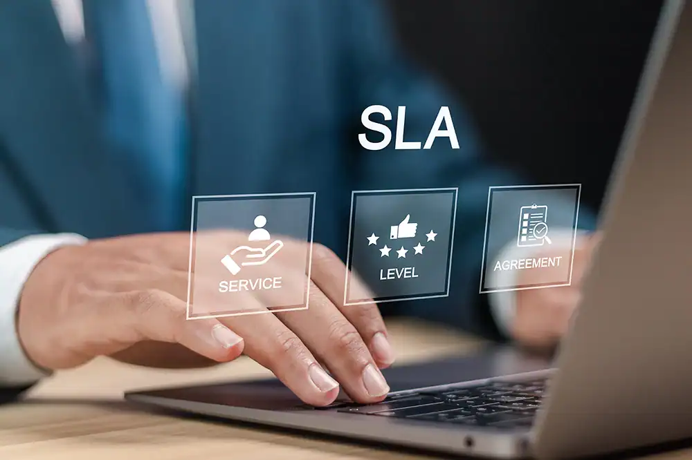 Hands typing with floating SLA icons.
